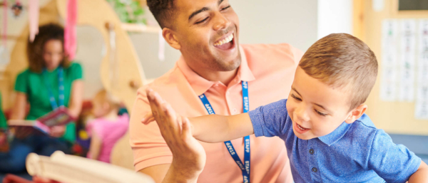 Teacher high fiving child