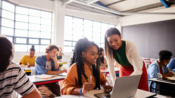 Students looking at laptop